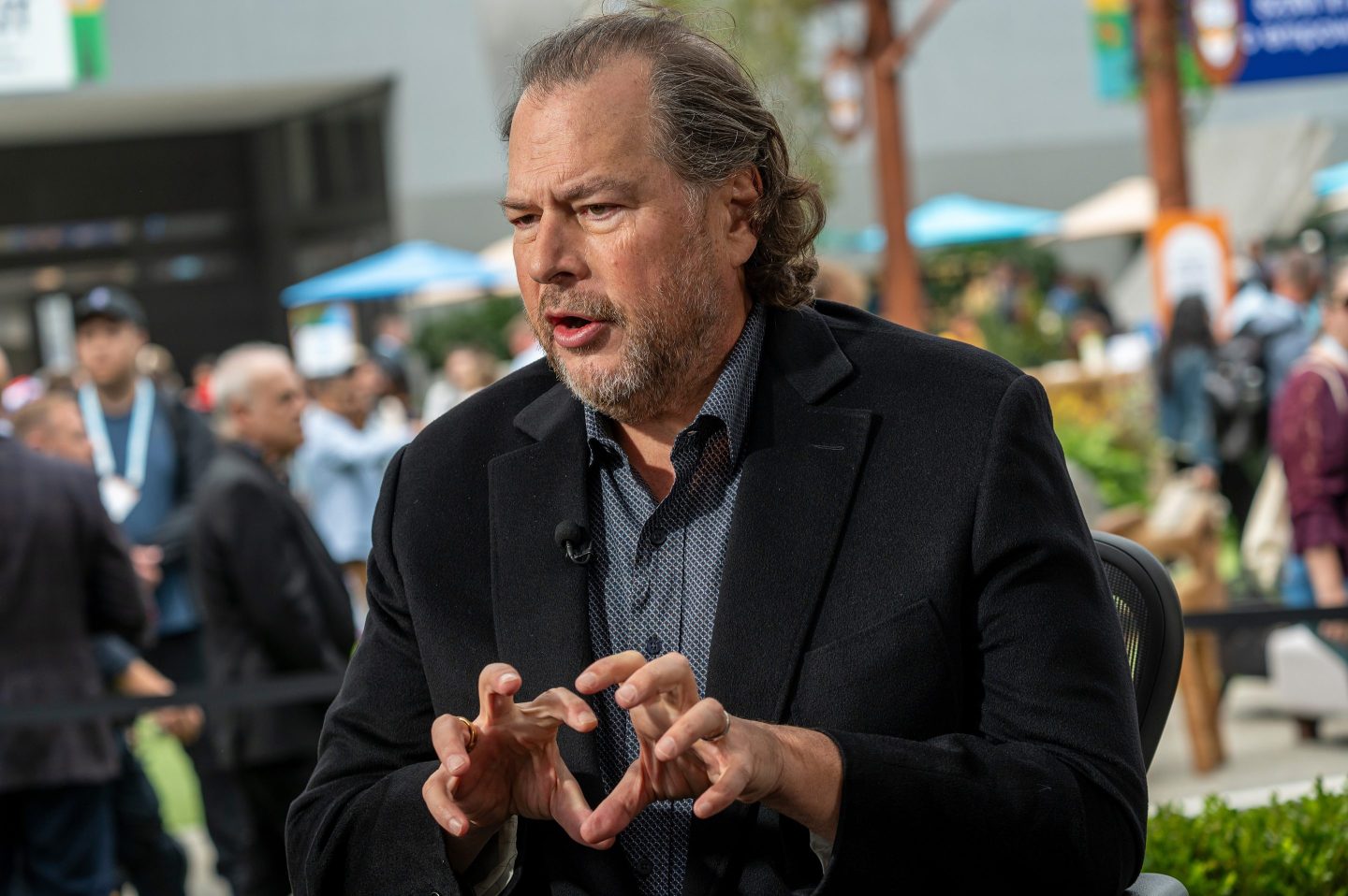 Marc Benioff speaks and gestures with both his hands in front of him.