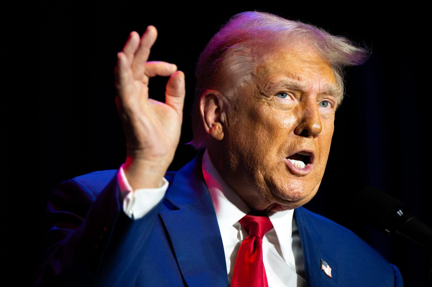 Donald Trump holds up hand