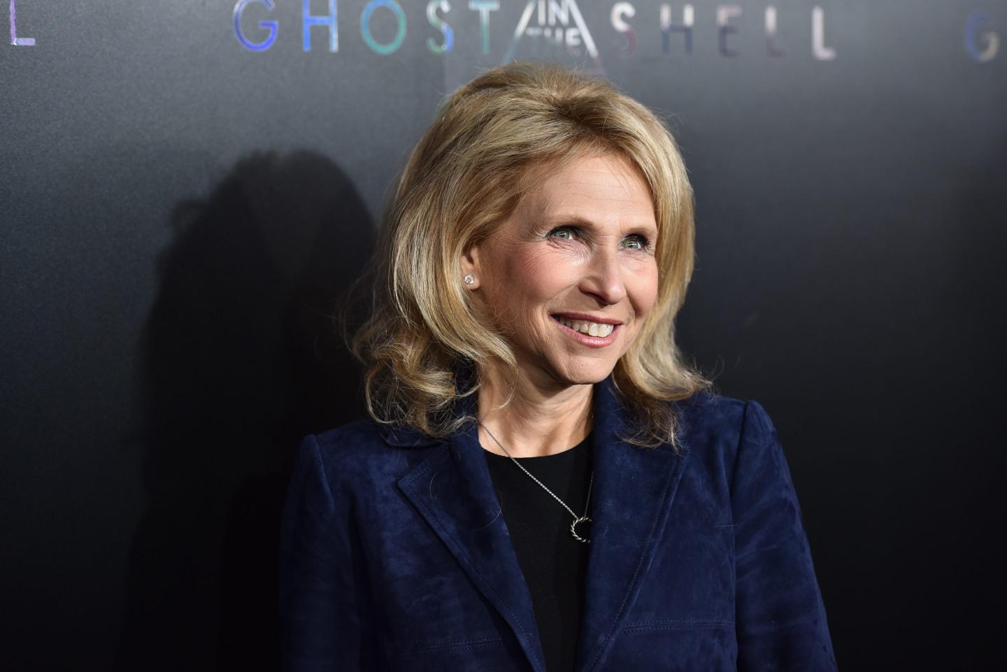 Shari Redstone appears at a red carpet event, with this close up shot showing her smiling in a dark indigo blazer and black top.