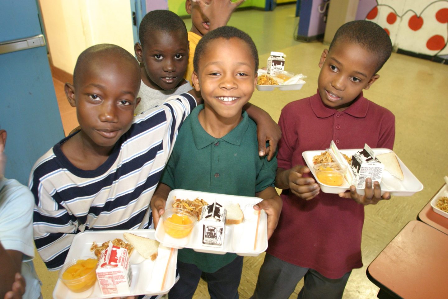 Boys holding their school lunches