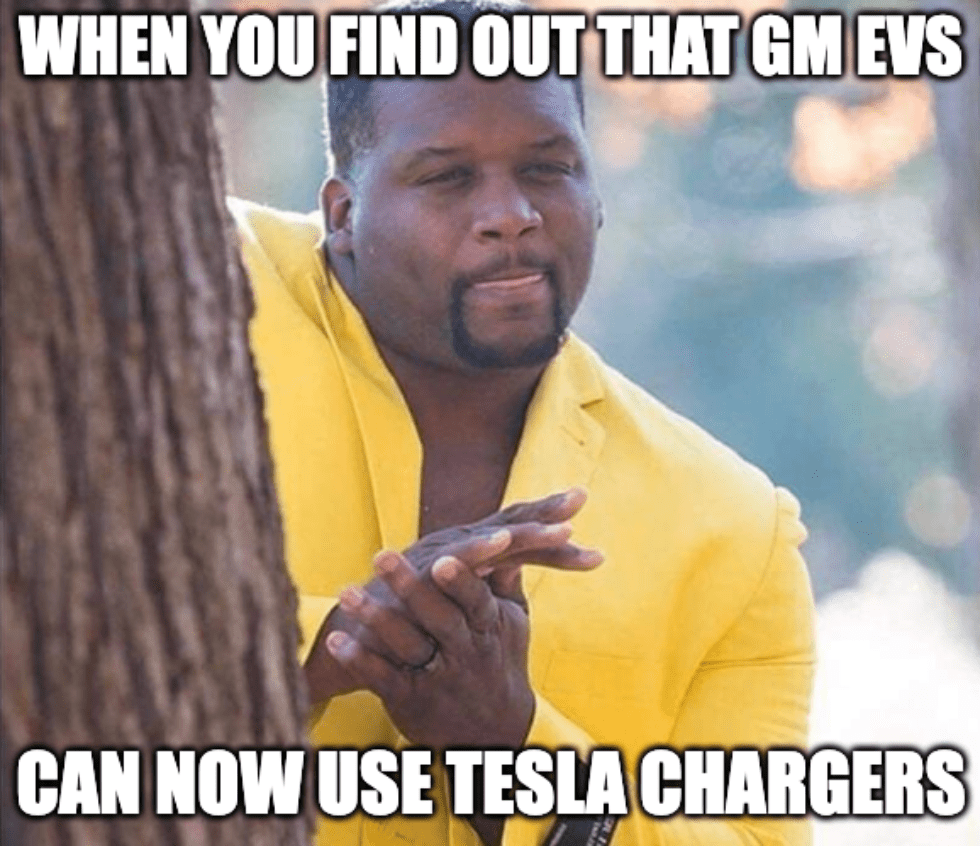 A meme featuring a man rubbing his hands that says, "When you find out that GM EVs can now use Tesla chargers."