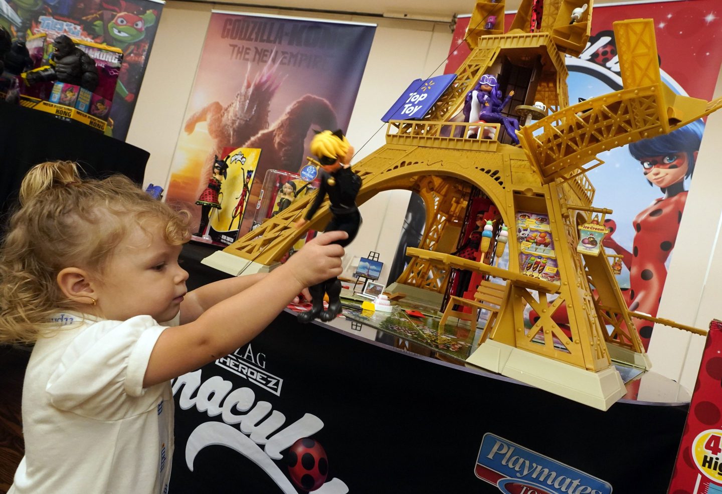 Reggie Rose Geschke, 2, plays with the Miraculous Paris Heroes Playset, from Playmates Toys, at the TTPM 2024 Holiday Showcase event, in New York, Sept. 17, 2024.