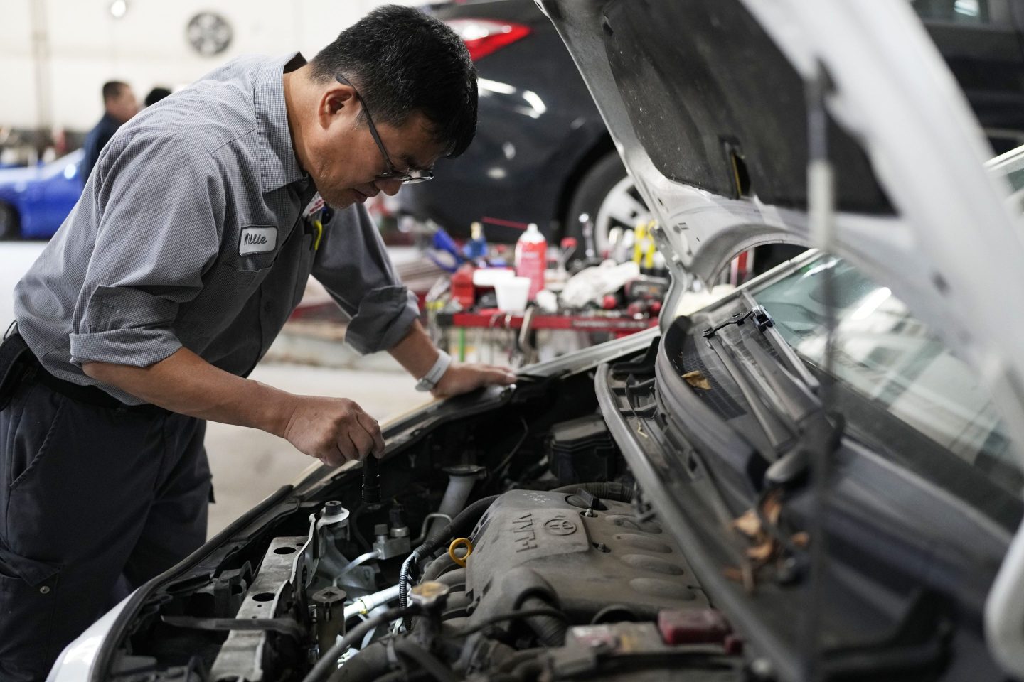 Auto mechanic Willie Chung works on a vehicle at the Express Auto Service Inc