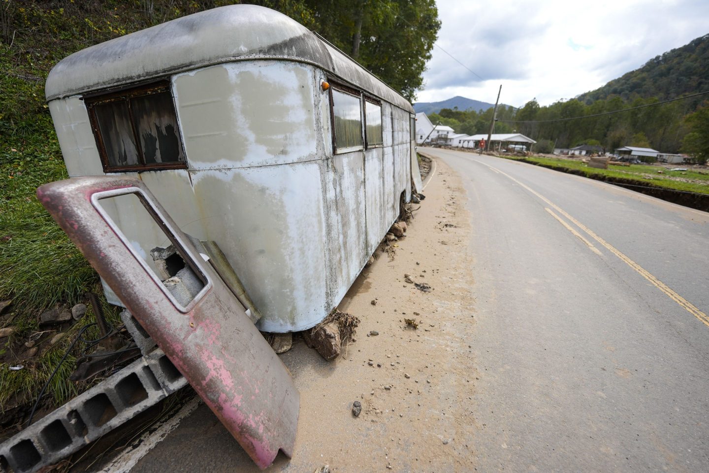 A trailer moved by floodwater sits on the side of a road in the aftermath of Hurricane Helene, Thursday, Oct. 3, 2024, in Pensacola, N.C.