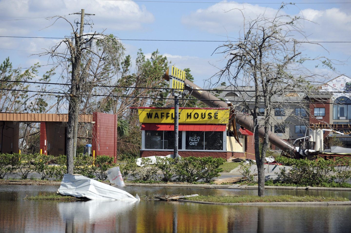 A billboard lies atop a Waffle House restaurant after being knocked down by Hurricane Michael in Panama City, Fla., on Oct. 14, 2018.