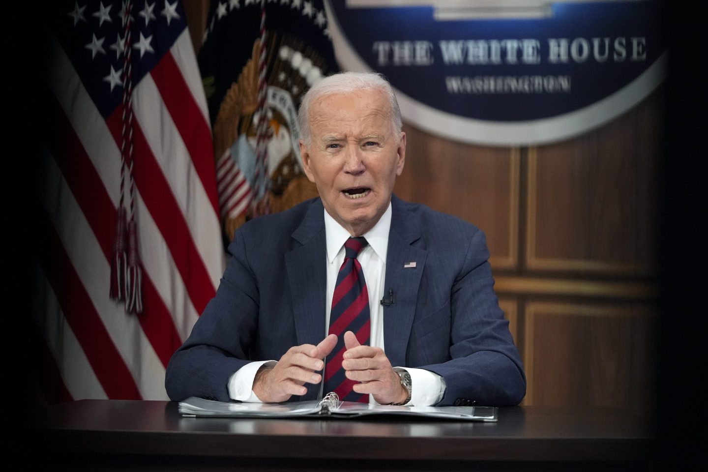 President Joe Biden is seen speaking at a podium.