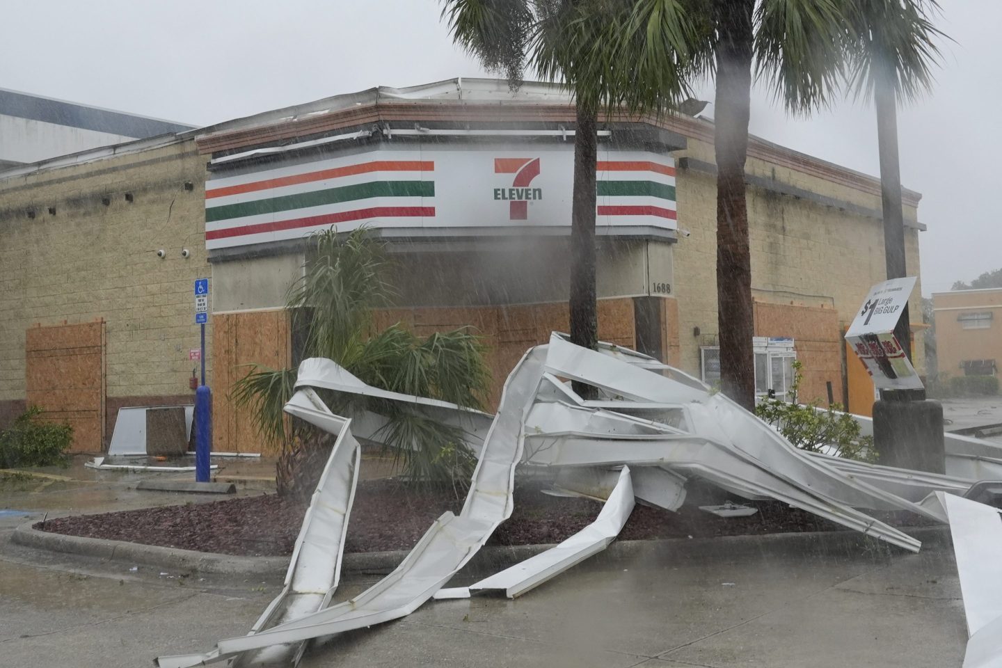 The awning is seen torn from a 7-Eleven convenience store after a tornado caused by Hurricane Milton.