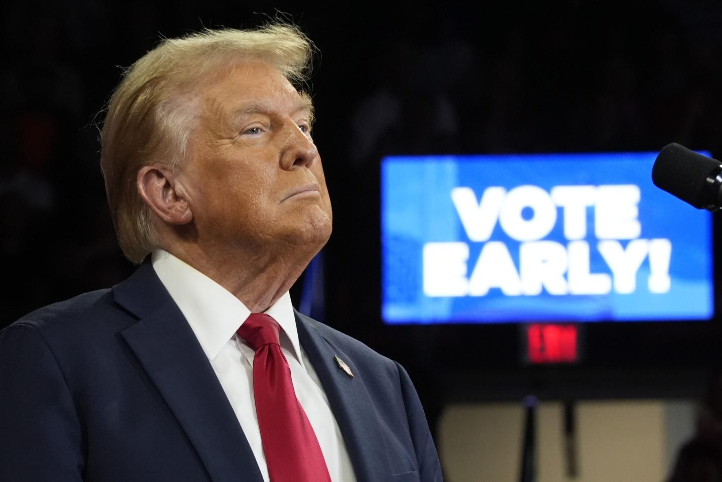 Trump stands in front of a sign saying "vote early," and he even said he would vote early, but it turns out he will vote on Election Day