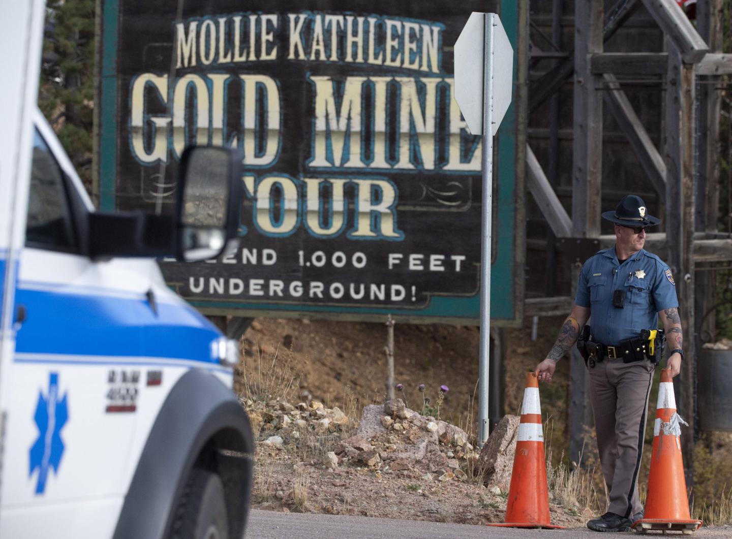 A police officer moves a barrier for an emergency vehicle Thursday.