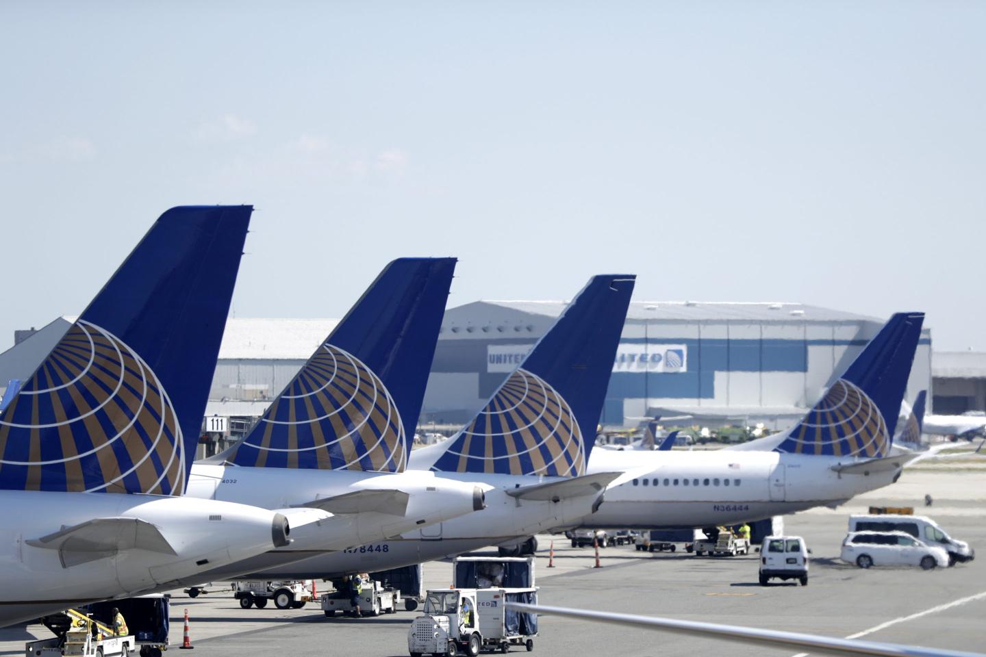 United Airlines jets sit at a gate