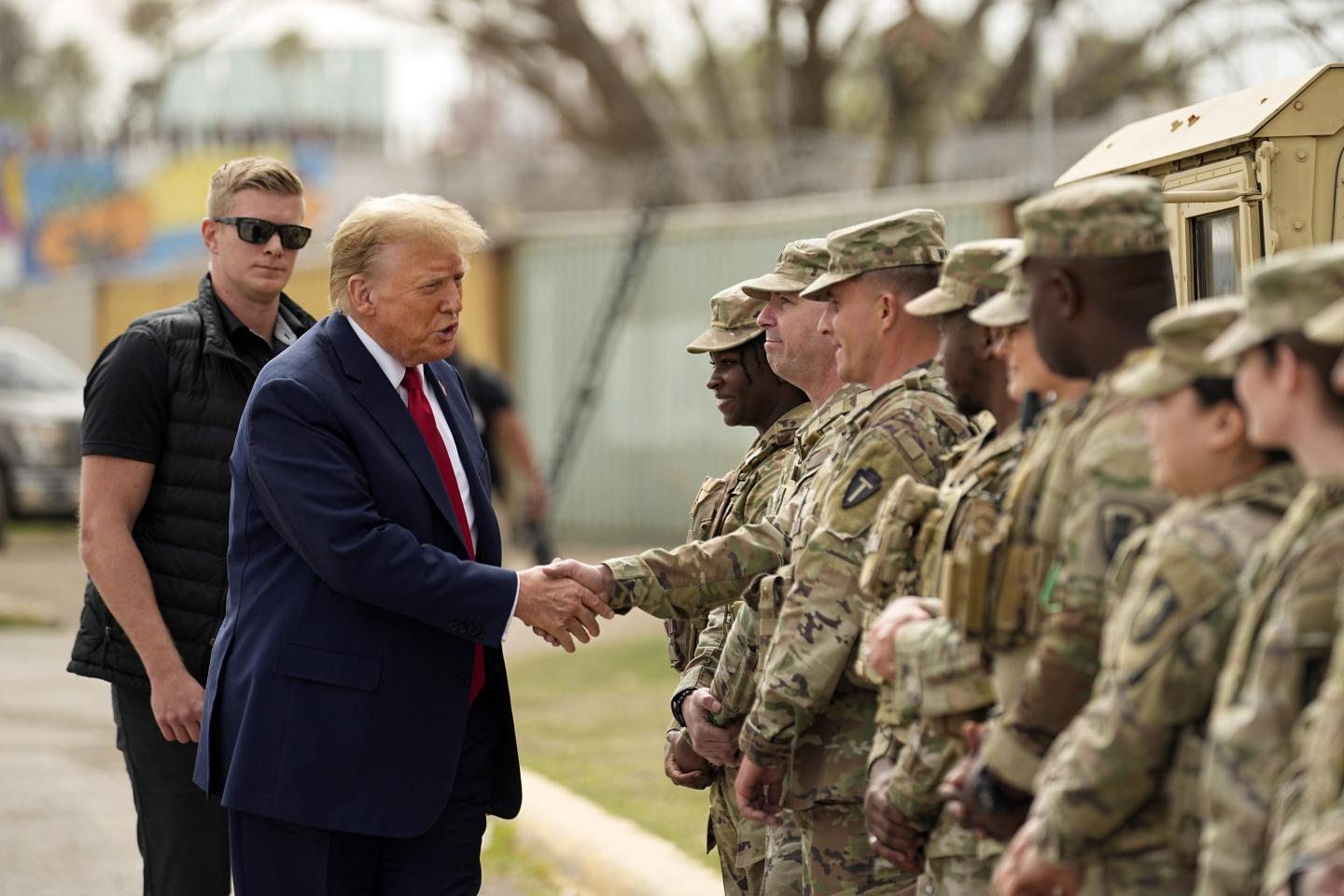 Trump shakes hands with soldiers