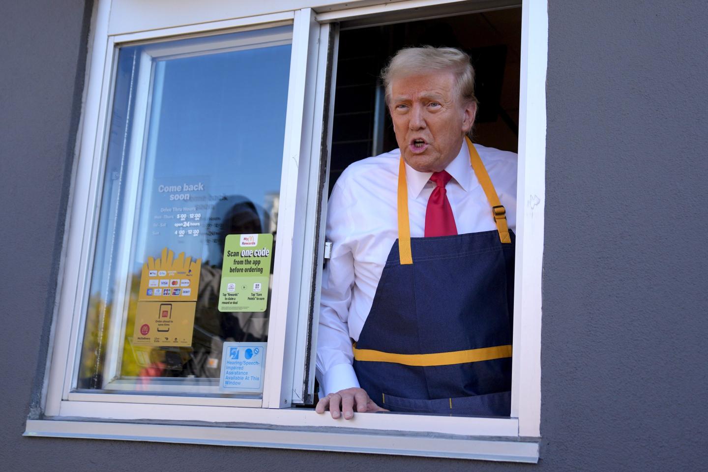 Republican presidential nominee former President Donald Trump speaks from a drive-thru window during a campaign stop at a McDonald's.