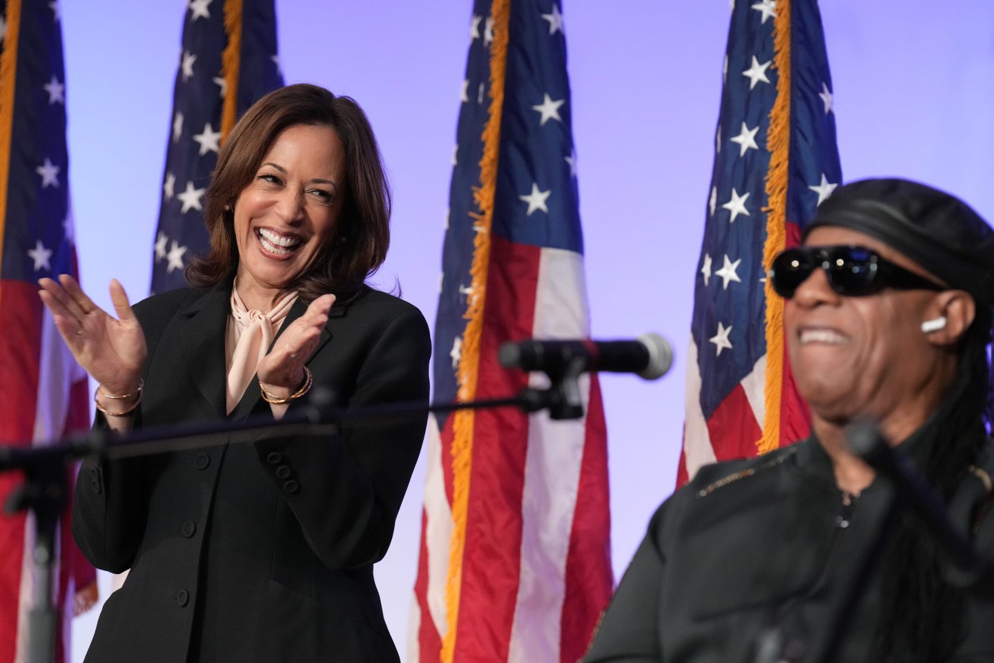 Democratic presidential nominee VP Kamala Harris listens as Stevie Wonder performs "Redemption Song" during a church service and early vote event at Divine Faith Ministries International, on Oct. 20, 2024, in Jonesboro, Ga.