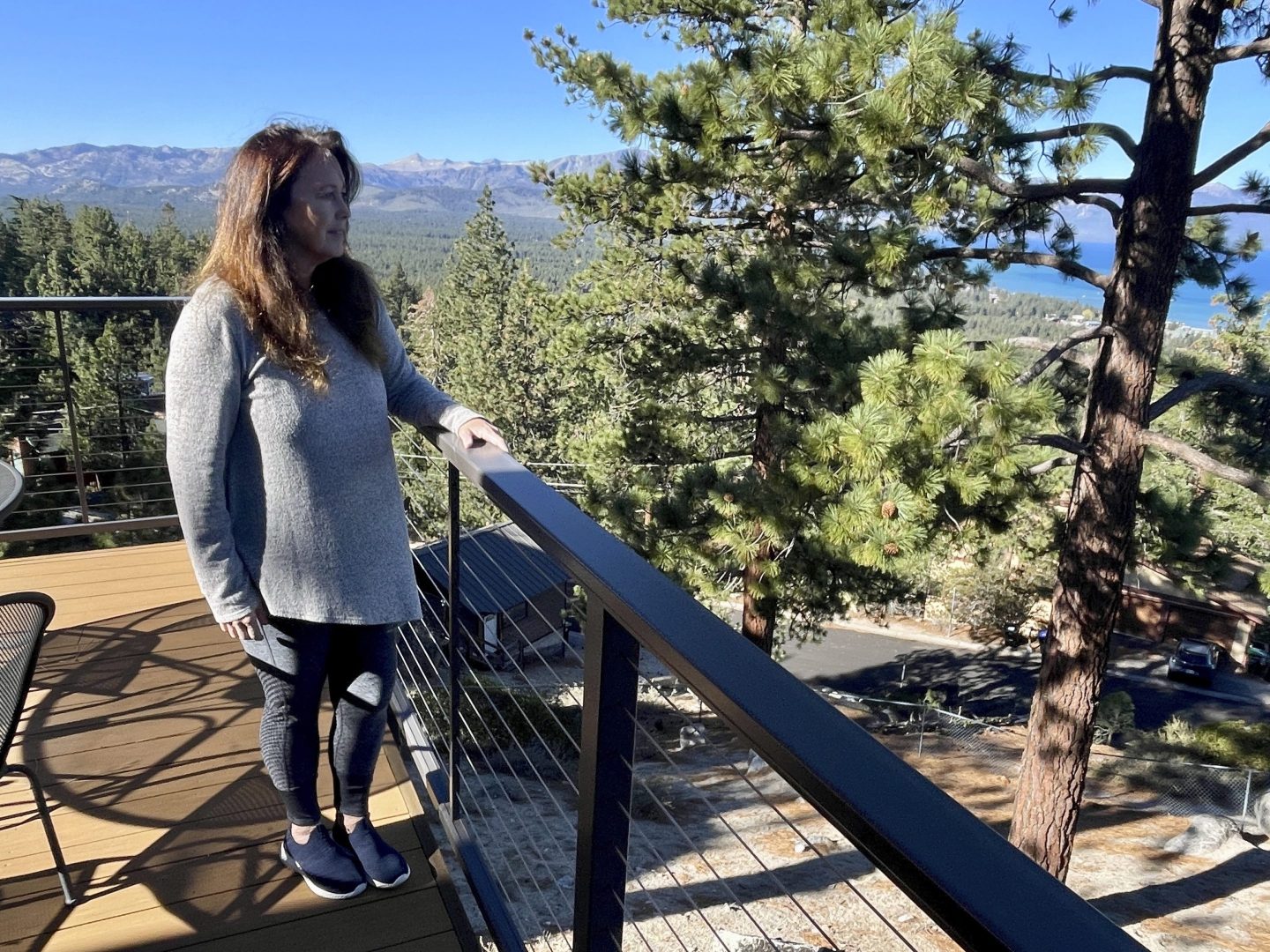 Homeowner Kelly O'Hare stands on her balcony overlooking South Lake Tahoe, Calif. on Oct. 18, 2024.