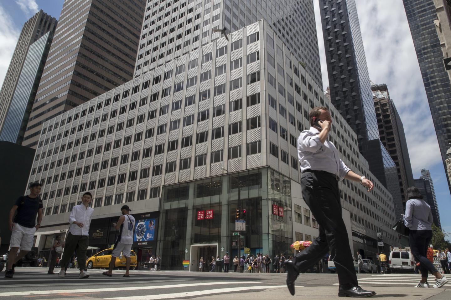 Pedestrians walk past 666 Fifth Avenue, June 20, 2018, in New York.