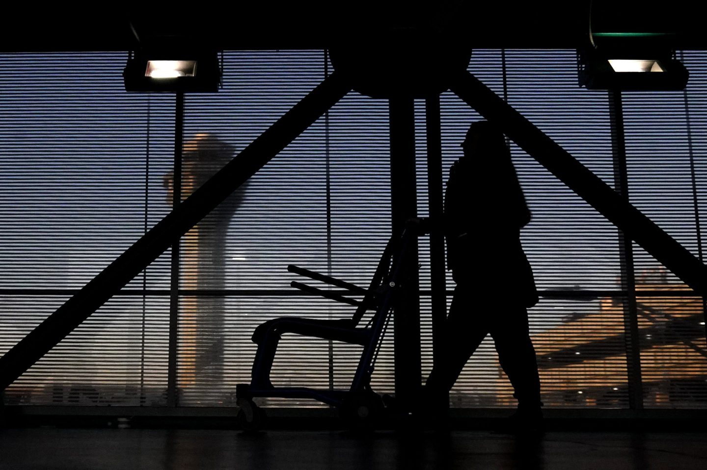 An airline employee transfers a wheelchair to her station at O'Hare International Airport in Chicago, Nov. 23, 2022.