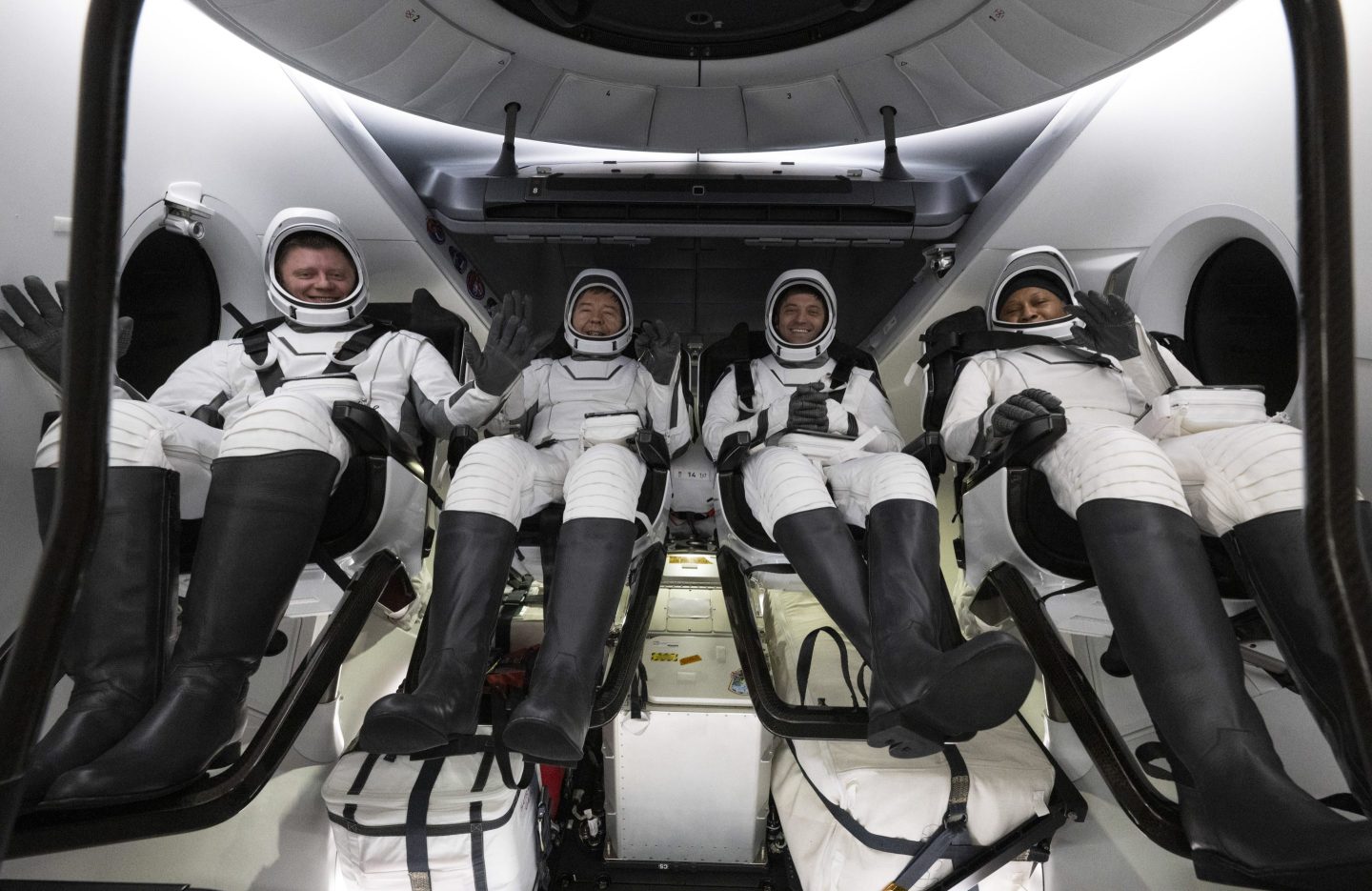 Four astronauts sitting in a SpaceX spacecraft