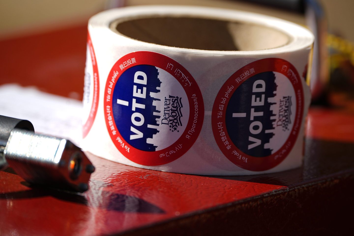 Stickers for voters sit in a roll on a ballot box at a voting drop-off location on Oct. 25, 2024, in Washington Park in Denver.