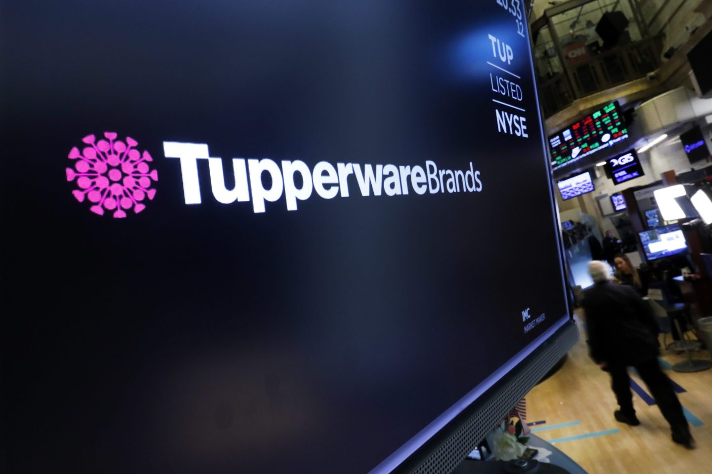The logo for Tupperware Brands appears above a trading post on the floor of the New York Stock Exchange on Oct. 30, 2019.