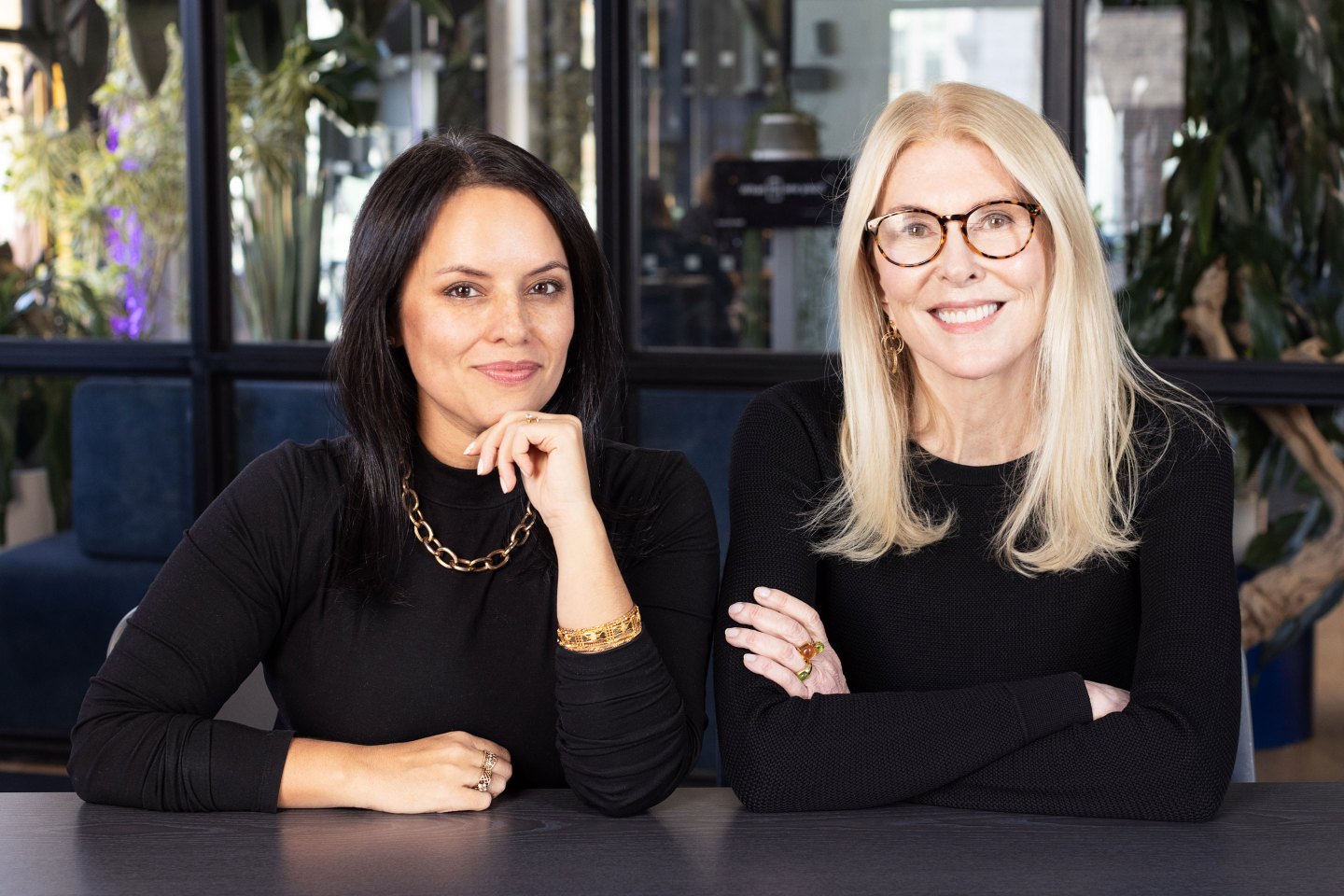 medium close-up of two businesswomen smiling for a portrait