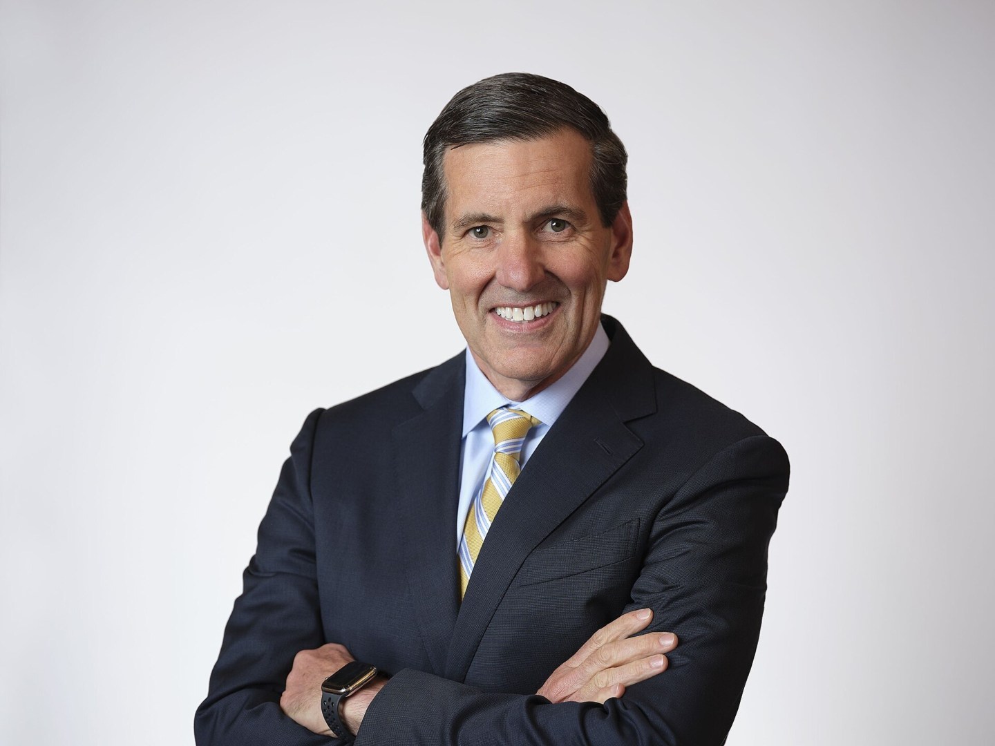 businessman wearing a suite and tie smiling for a portrait