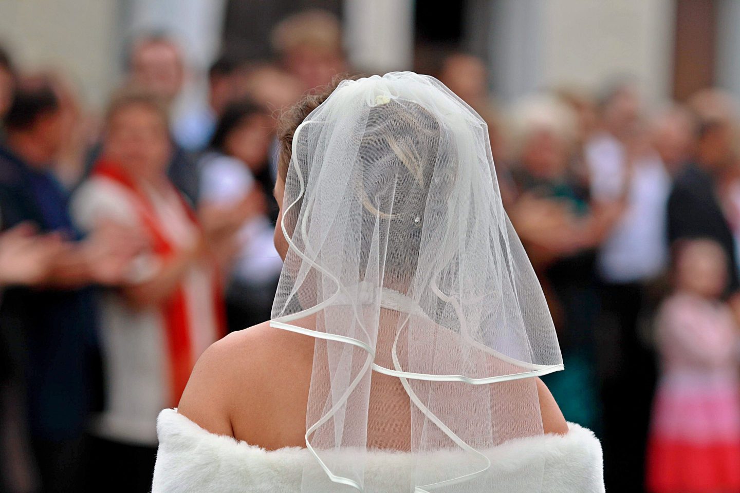Photo of a bride wearing a veil and gown