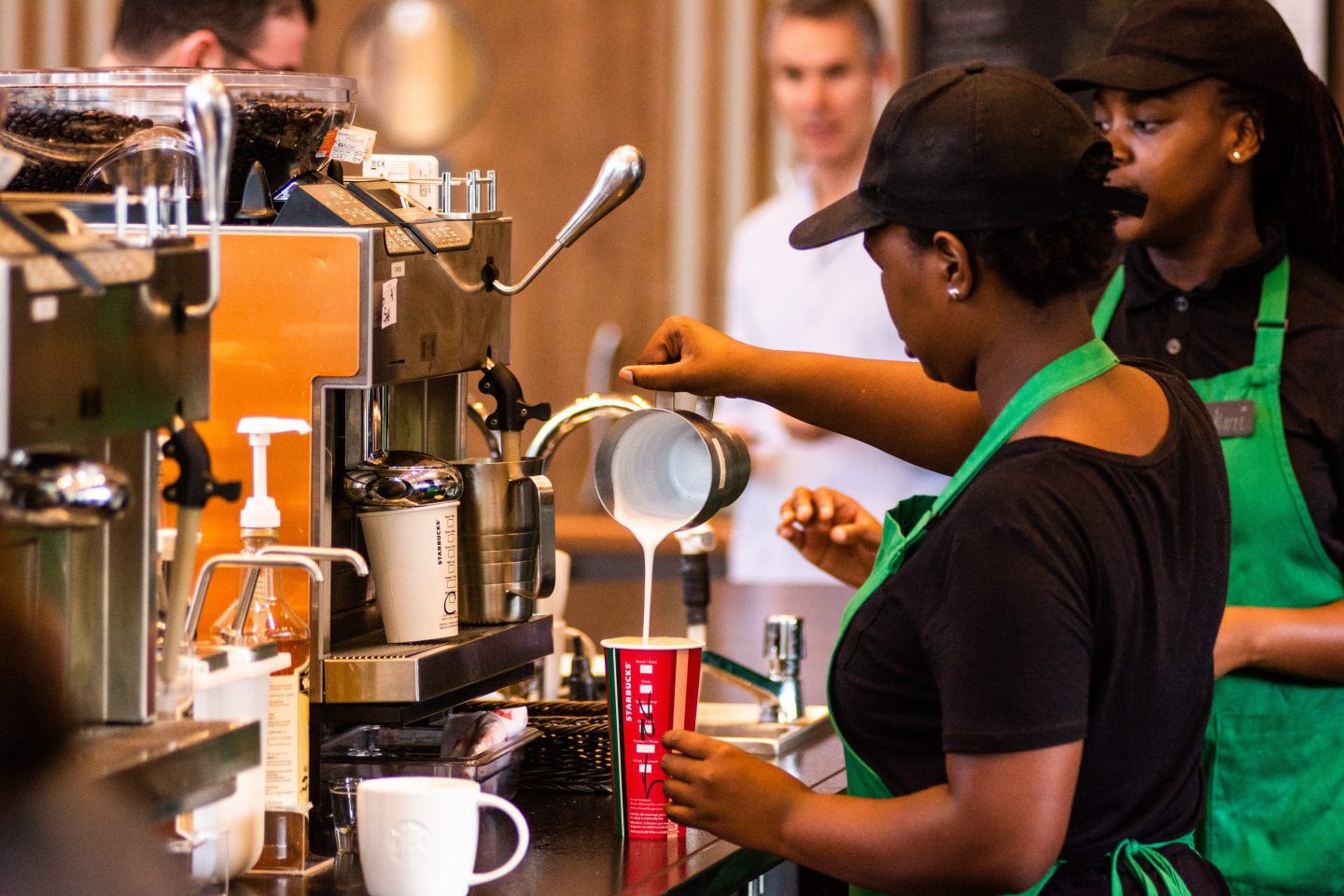 A barista pours steamed milk into a beverage inside a Starbucks Corp. cafe in the Sandton area of Johannesburg, South Africa.