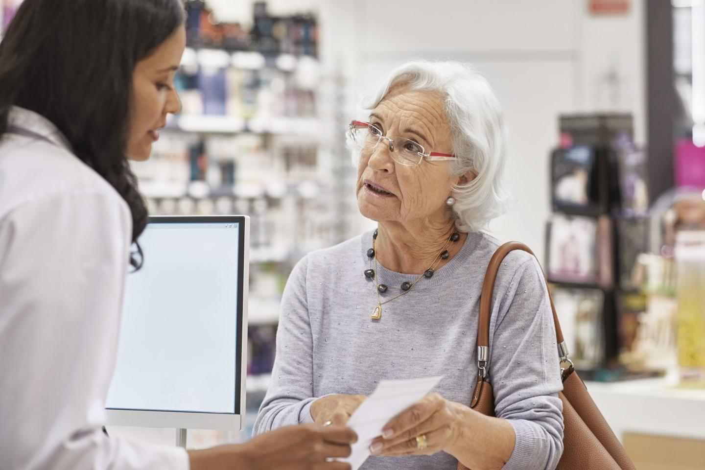 Photo of a woman speaking to a pharmacist