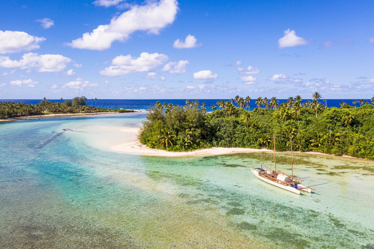 Photo of a sailboat in a peaceful blue lagoon