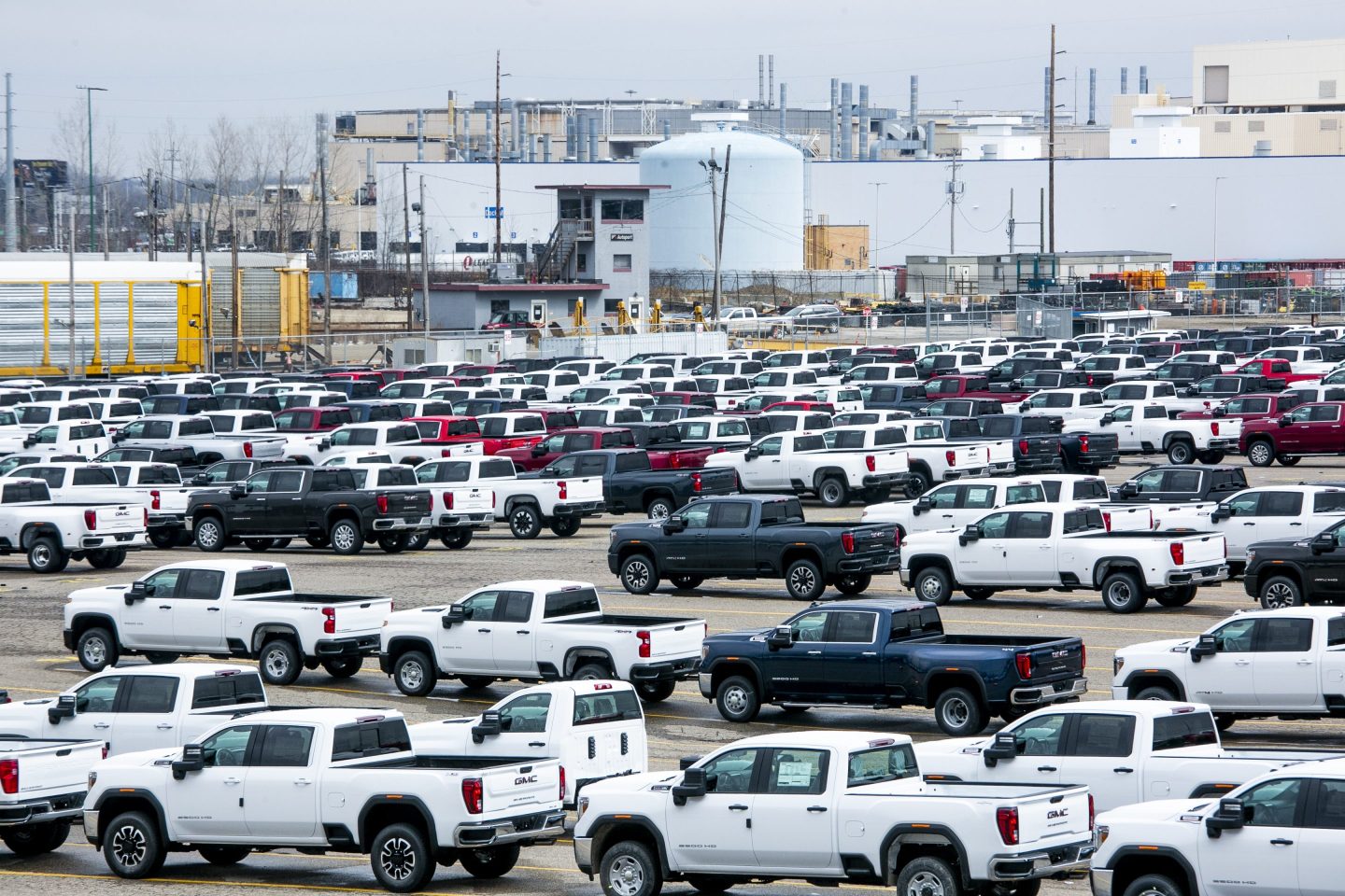 New vehicles sit in a lot in front of the idled General Motors Co. Flint Assembly plant in Flint, Michigan, U.S., on Monday, March 23, 2020.