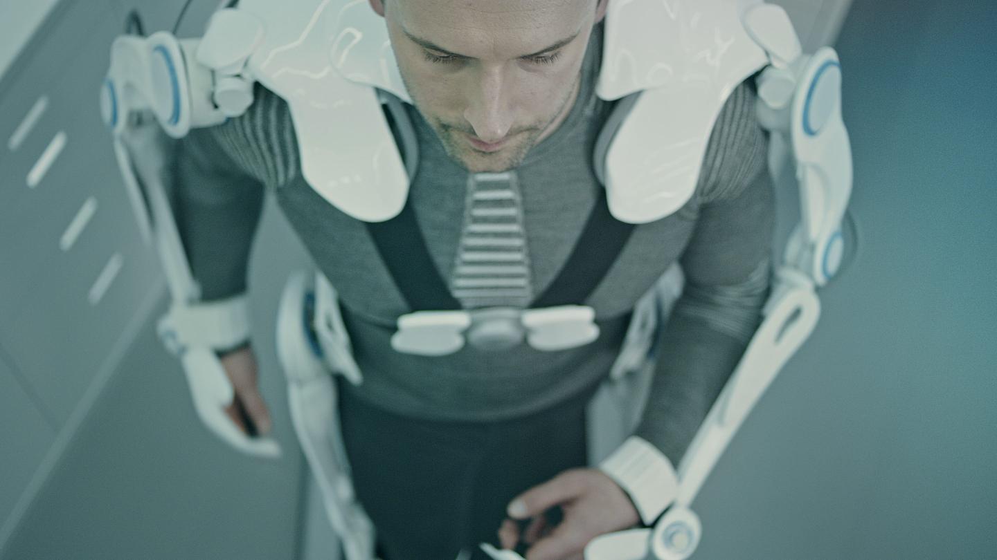 Man wearing and testing exo suits in Laboratory.