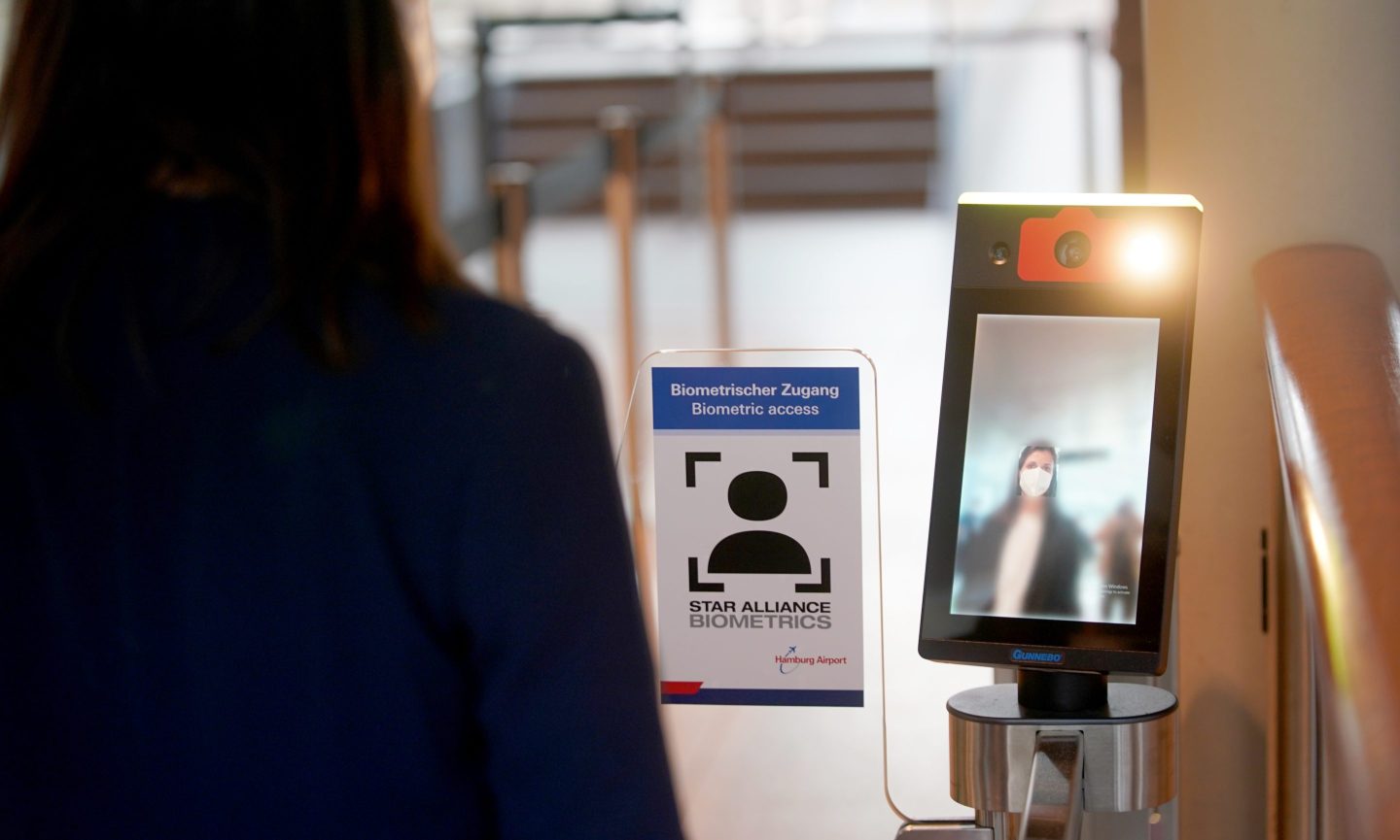 An airline passenger uses facial recognition technology.