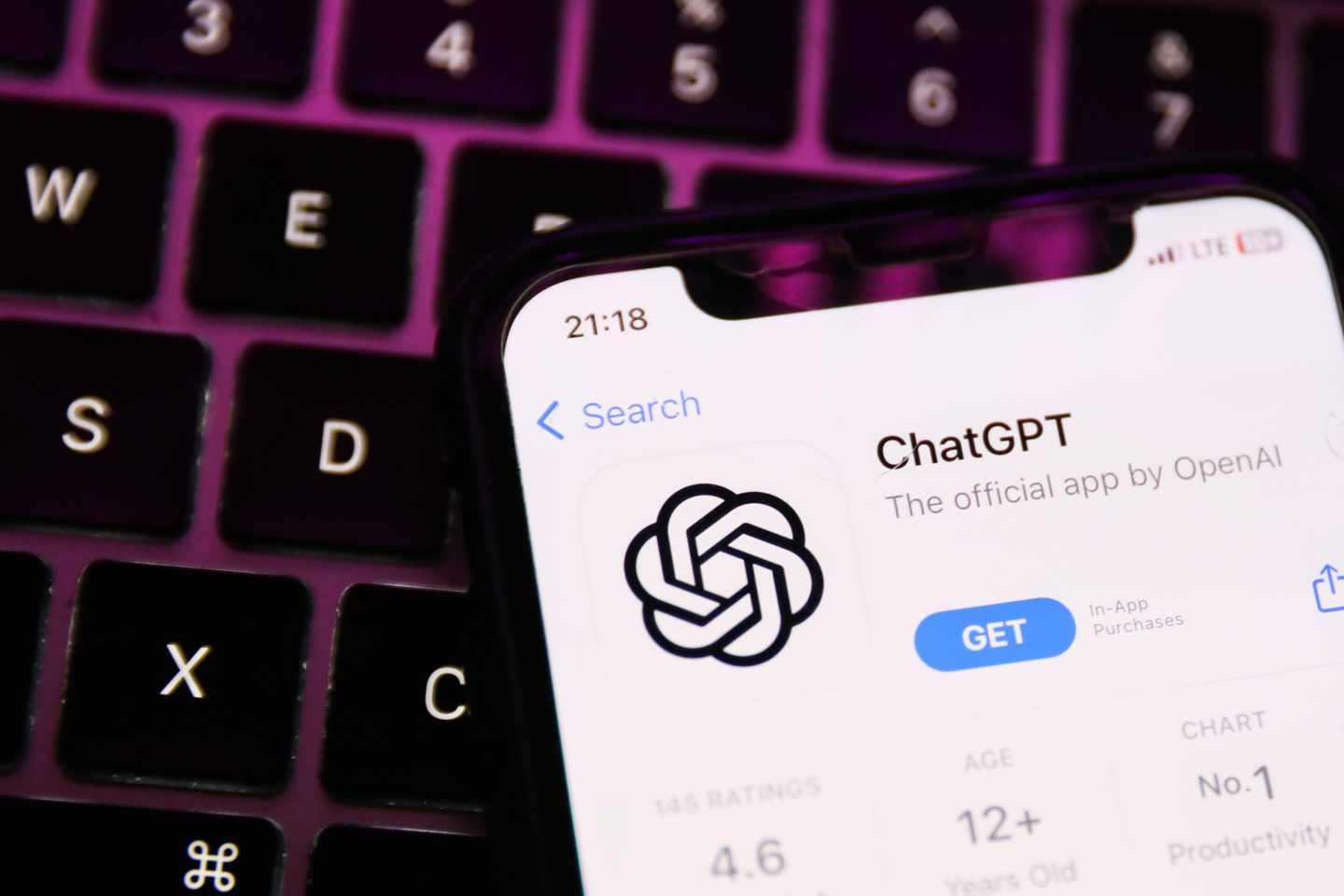 A laptop keyboard and ChatGPT on AppStore displayed on a phone screen are seen in this illustration photo.