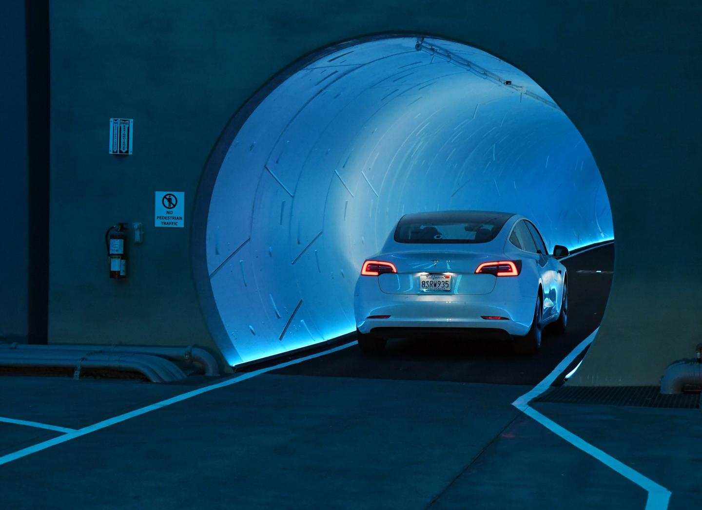 Photo of a Tesla car entering a tunnel