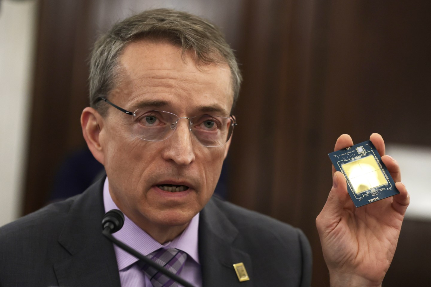 Intel CEO Pat Gelsinger holds up a semiconductor chip during a congressional hearing in 2022.