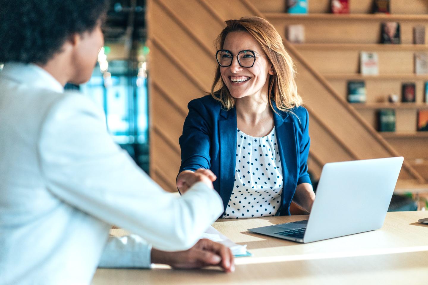 Recruiter meets candidate at interview.