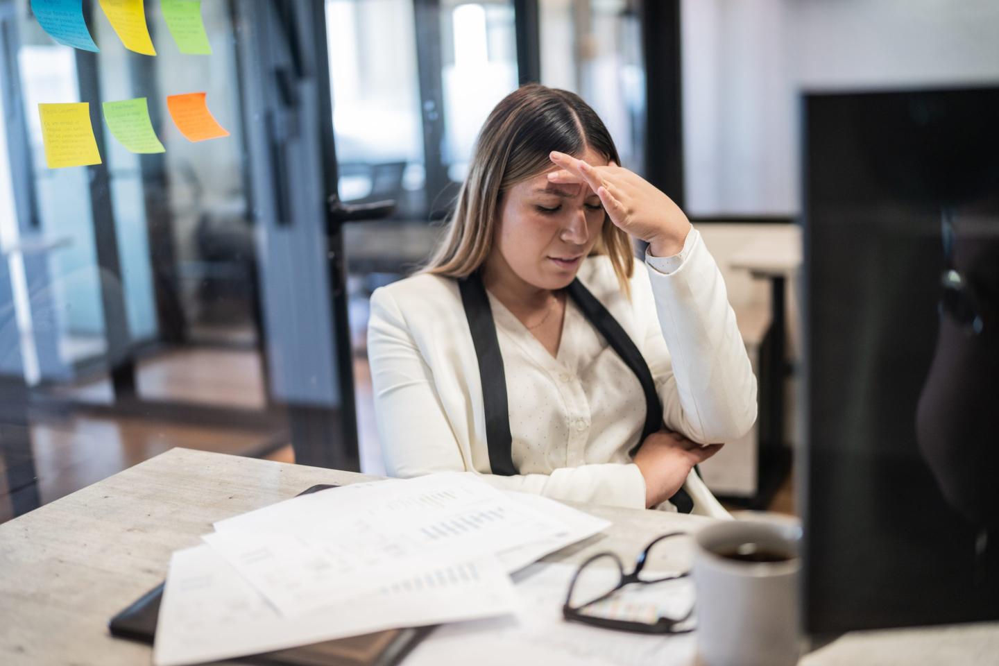 Woman looking distressed sitting at desk