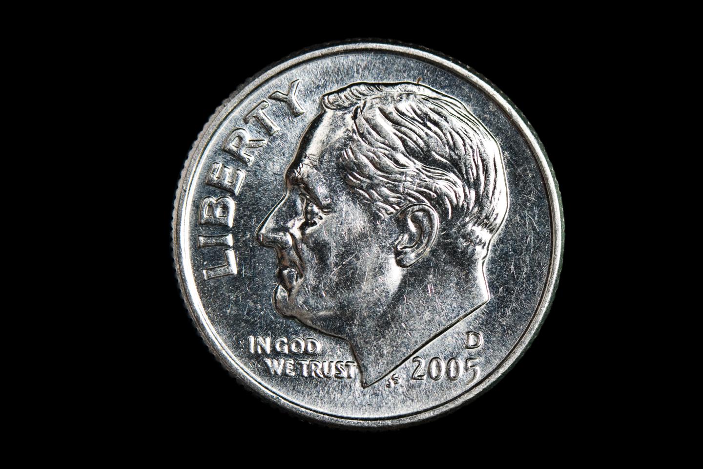 Dime on black background.