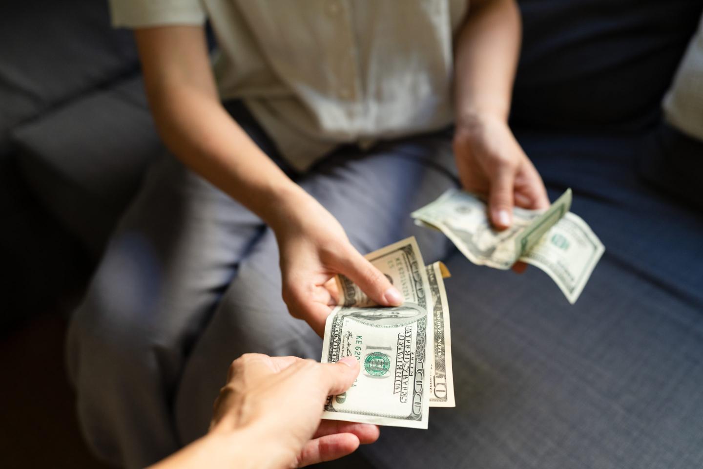 One person hands another money