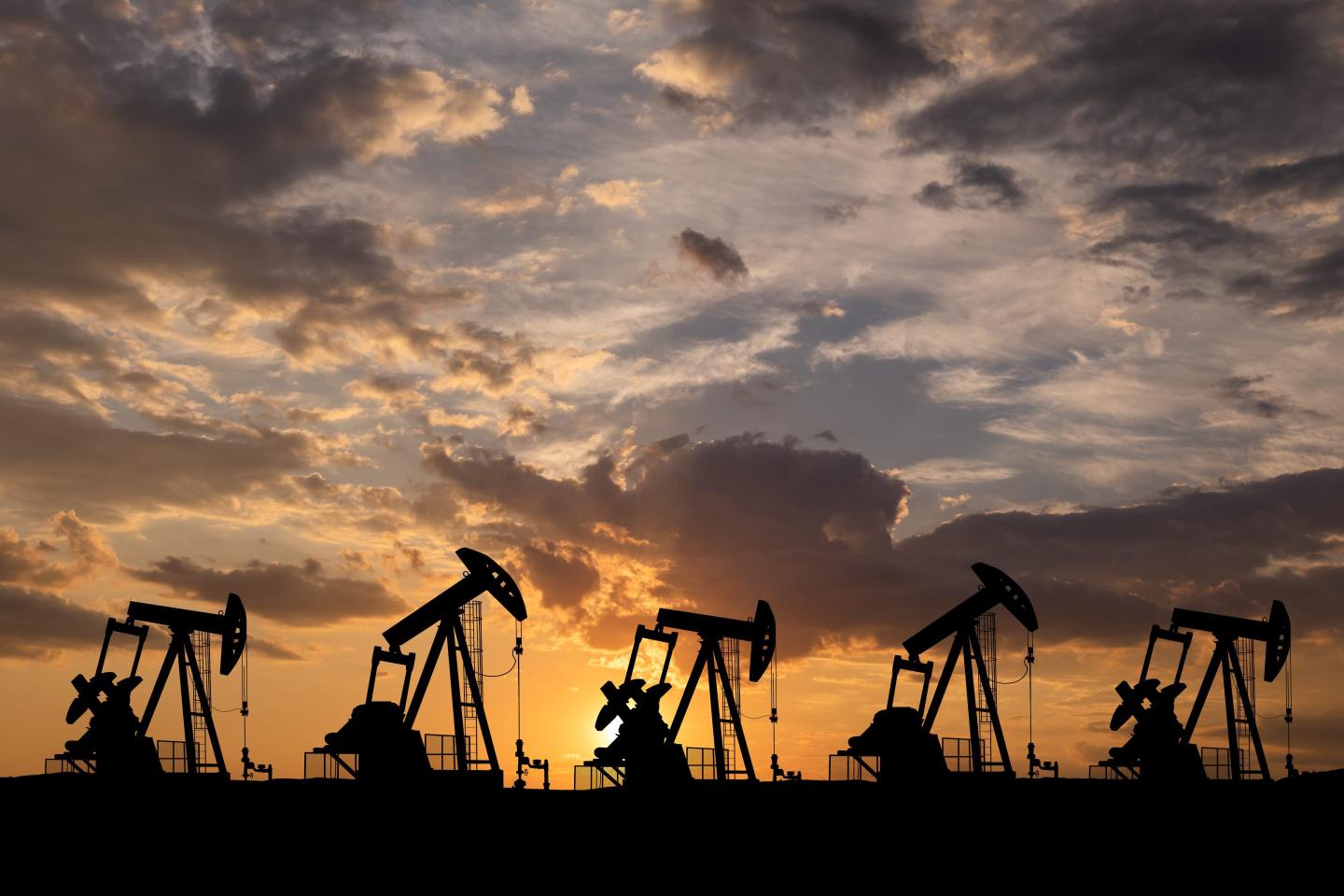 oil rigs at sunset