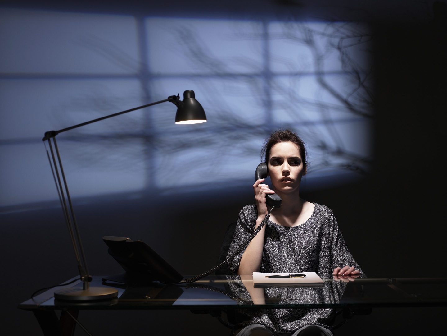 HR leader sits at desk scared.