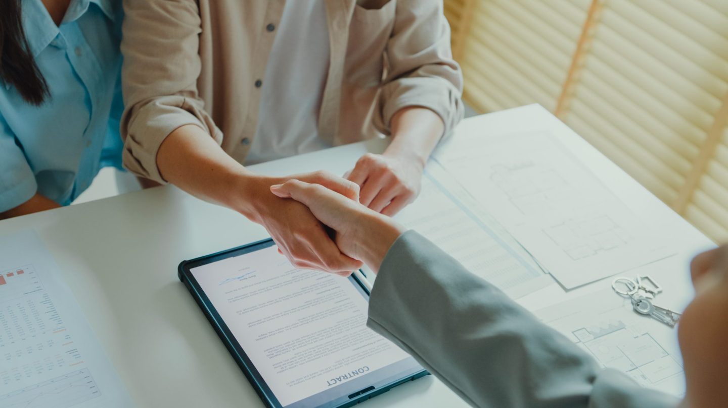 two lawyers shake hands