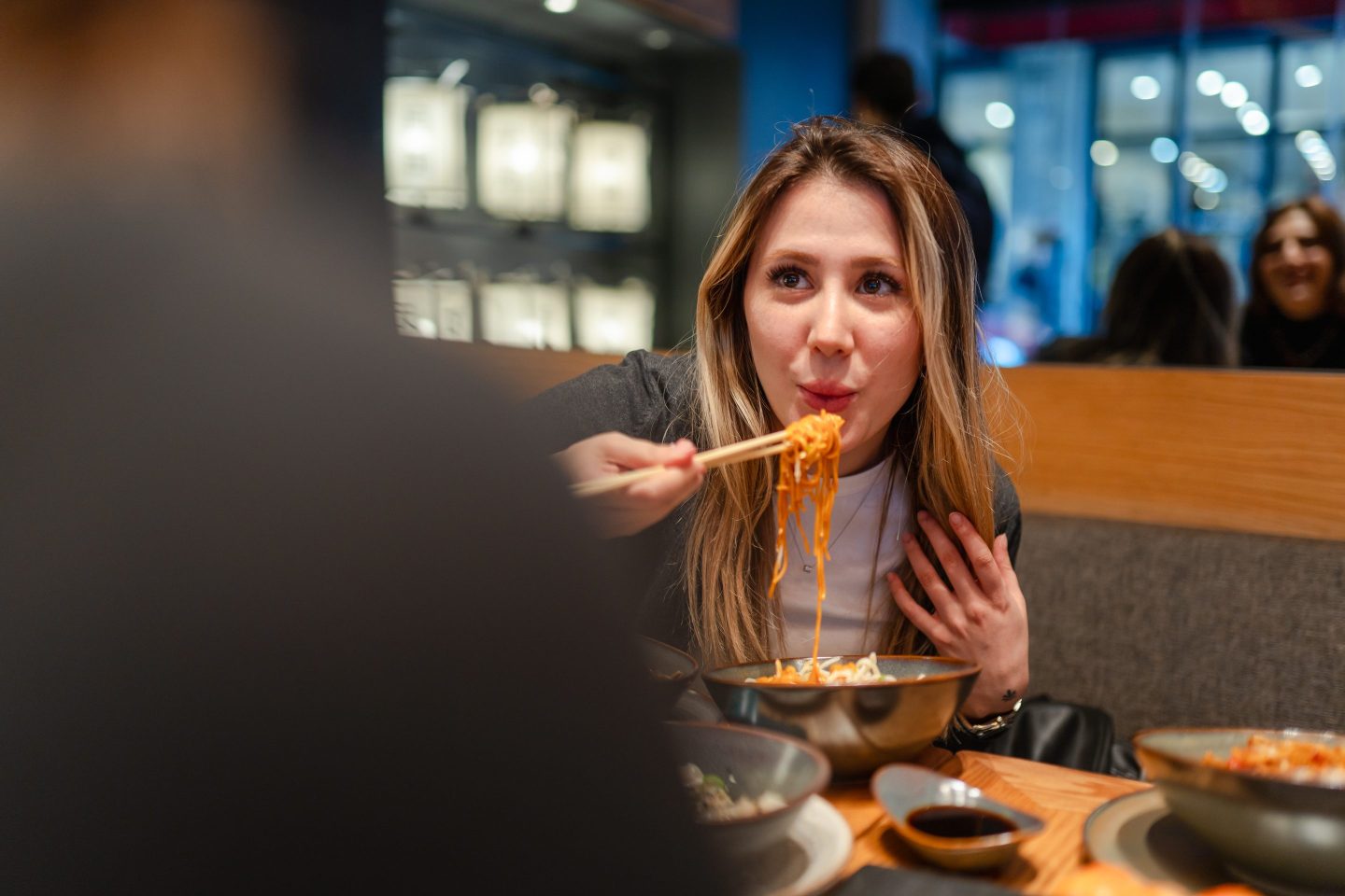 Young woman going out with her friend to eat noodles for dinner