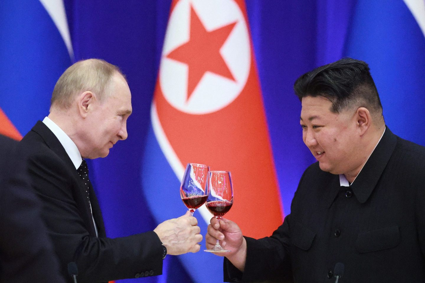 Vladimir Putin and Kim Jong Un toast