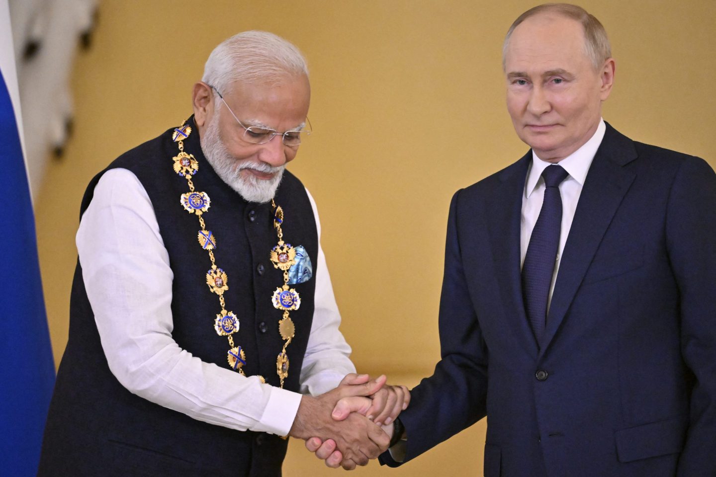 Narendra Modi and Vladimir Putin shake hands