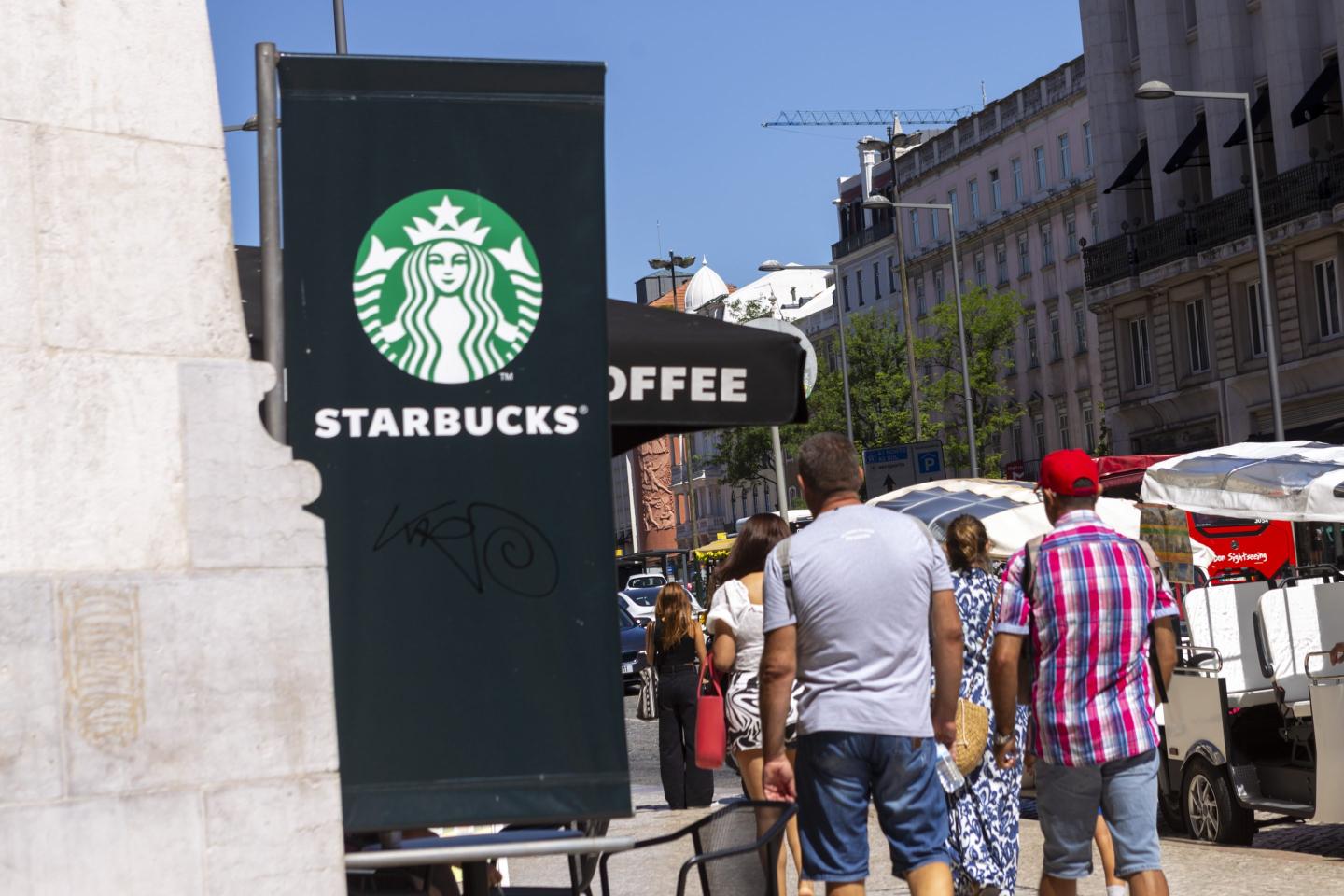 A general view of people walking by a Starbucks Coffee store
