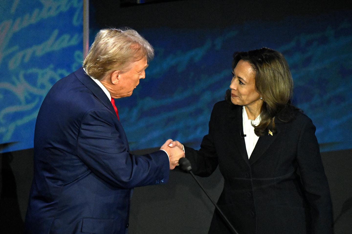 Kamala Harris (right) shakes hands with Donald Trump on Sept. 10
