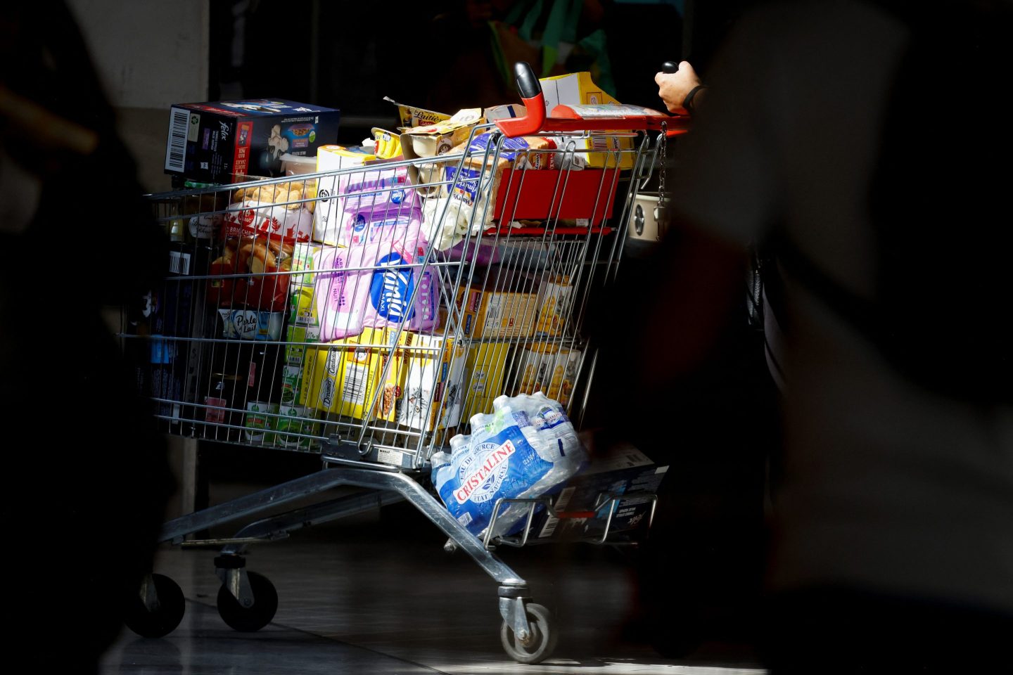 A customer pushes a shopping cart as they shop for groceries at a Carrefour Group hypermarket store in Drancy, outside Paris on Sept. 11, 2024.