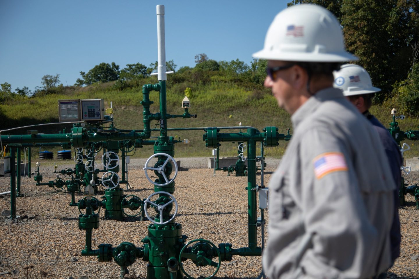 Employees stand by a natural gas well in Franklin Township, Washington County, Pennsylvania on Sep. 6.