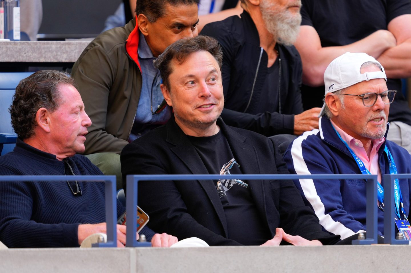 Elon Musk sits and watches the U.S. Open.